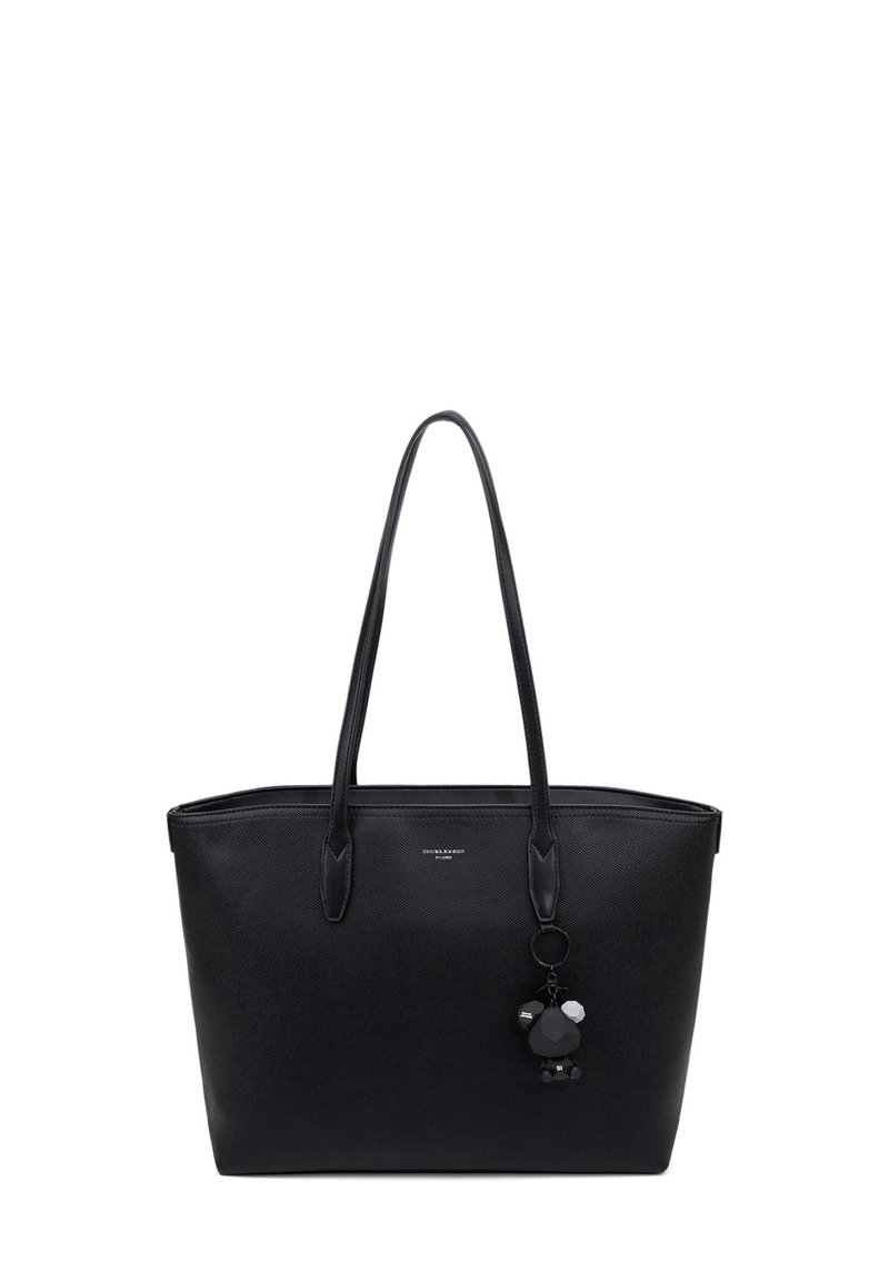Black tote bag with textured material, slim handles, a rectangular shape, and a decorative charm featuring geometric shapes and accents.