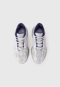 Pair of white and light purple Lacoste sneakers with mesh and synthetic upper, navy interior lining, and lace-up closure on white background.