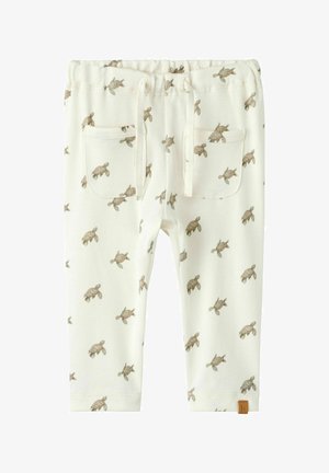 Crèmekleurige peuterbroek met bruine zeeschildpadprint, elastische tailleband, trekkoord en twee voorzakken.