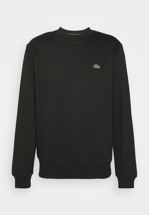 Sort sweatshirt med lange ærmer og rund hals. Har et lille grønt og hvidt broderet logo på venstre bryst. Glat tekstur.