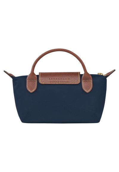 Navy nylon tote bag with brown leather handles and accents. Features a gold zipper and embossed logo on the leather flap. Compact design.
