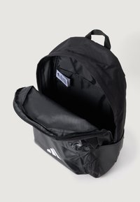 Black backpack made of durable fabric featuring a zippered compartment, interior pocket, and white logo detail on the front.