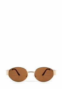 Brown oval sunglasses with a gold metal frame and clear temple accents. Lenses are solid brown, providing full coverage.
