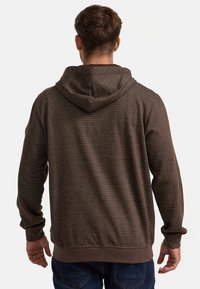 Brown hoodie with a textured finish, featuring a drawstring hood, long sleeves, and ribbed cuffs and hem. Visible stitching detail.