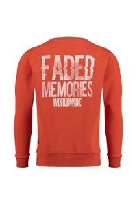Maglione arancione con maniche lunghe, polsini a coste e colletto girocollo. Sul retro è presente il testo "FADED MEMORIES WORLDWIDE" in bianco.