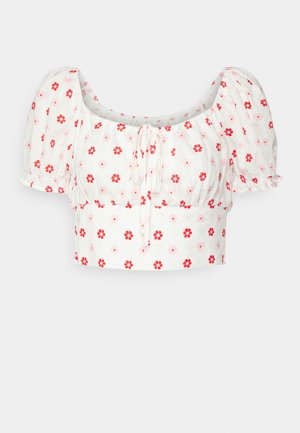 Witte crop top met pofmouwen, een ronde hals en een bloemenprint in rood en roze. Het materiaal lijkt licht en textuur te hebben.