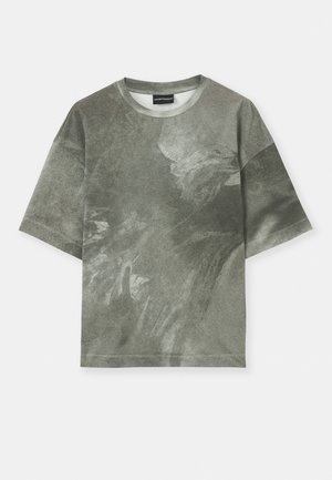 Short-sleeve, gray-green t-shirt with an abstract eagle graphic and a crew neckline, displayed on a white background.