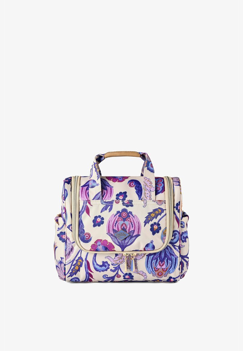 Sac crème à motif floral avec des dessins violets et roses, poignées doubles avec prise beige, poche avant à rabat et tirettes de fermeture éclair dorées.