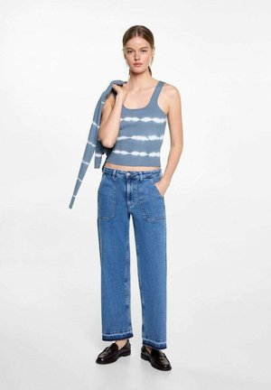 Ribbed blue crop top with white tie-dye pattern, paired with high-waisted wide-leg denim trousers, featuring front pockets and cuffed hem.