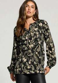 Schwarze Bluse mit floralen und Paisleymustern in Creme, langen Ärmeln mit gerafften Manschetten und einem durch Knöpfe geschlossenen Henley-Ausschnitt.