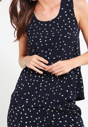 Top senza maniche di colore navy realizzato in tessuto leggero, con un motivo di foglie metalliche sparse e una vestibilità rilassata con orlo arrotondato.