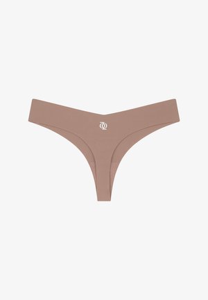 Nude-colored thong underwear with a smooth texture, wide waistband, and a subtle logo in the front center. Minimalist design.