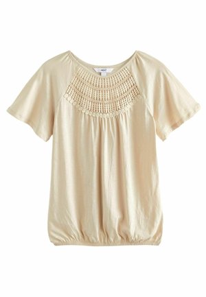 Beige short-sleeve blouse with round neckline, elastic hem, and intricate crochet lace detail across the chest.