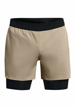 Beige athletic shorts with a black elastic waistband, featuring a built-in black compression layer below. Smooth texture, minimalist design.