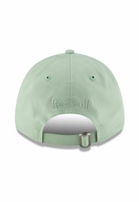 Light green baseball cap with a curved brim, adjustable strap, and embroidered "Red Bull" logo on the back. Made of textured fabric.