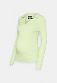 T-shirt de maternidade em verde claro com pregas, mangas longas, colarinho em V e franzidos laterais para um ajuste ajustado à volta da barriga.