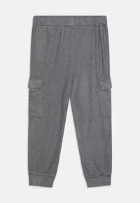Gray sweatpants with an elastic waistband, two side cargo pockets, cuffed ankles, and a soft, textured fabric.