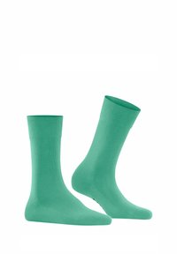 Grüne Baumwollsocken mit glatter Textur, mittellanger Knöchel Länge und einem gerippten Bund. Einfaches Design, keine Muster oder zusätzlichen Details.