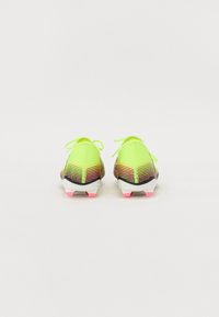 Football boots with a bright neon yellow upper, multi-colored gradient pattern, black base, and pink accent on the sole.