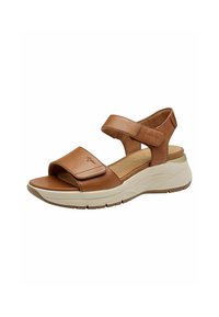 Braune Leder-Sandale mit einem breiten oberen Riemen und verstellbarem Knöchelriemen. Verfügt über ein gepolstertes Fußbett und eine leichte, beiger Sohle.