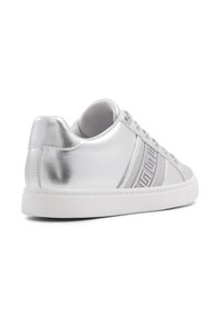 Silver metallic sneakers with a smooth texture, featuring white soles and gray decorative stripes. Includes embossed detailing on the side.