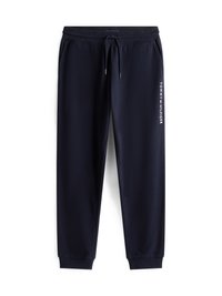 Námořnické sportovní kalhoty s elastickým pasem, šňůrkami a zúženými nohavicemi. Na levé straně se nachází bílé logo 'TOMMY HILFIGER'.