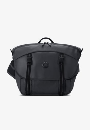 Black, soft-textured messenger bag with a curved top, dual front buckles, and a central zippered compartment. Adjustable shoulder strap included.