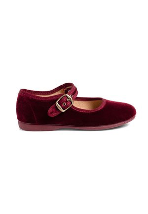 Burgundy velvet Mary Jane shoe with a rounded toe, flat sole, and a buckled strap across the instep. Smooth texture and minimalistic design.
