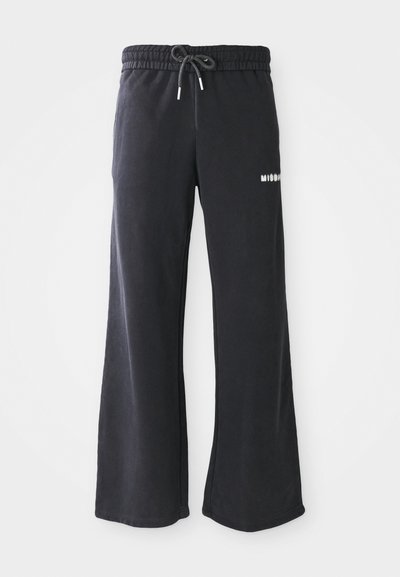 Sorte sweats lavet af et blødt stof, med en bred ben-design, elastisk talje med snøre og en lille hvid logo detalje.