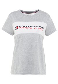 Šedé tričko s krátkým rukávem s bílým vodorovným pruhem a logem "TOMMY SPORT" v červené a tmavě modré barvě. Hladká bavlněná látka s volným střihem.