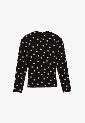 Melns garām piedurknēm krekls ar atkārtojošu krēmkrāsas saules formu rakstu, izgatavots no mīksta auduma ar apaļu dekoltē.
