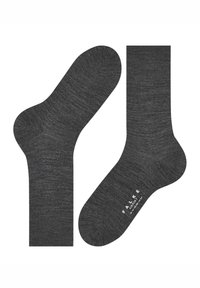 Mørkegrå sokker lavet af et blødt, tekstureret materiale. Har et sømløst design og ribbet kant, med synlig branding på sålen.