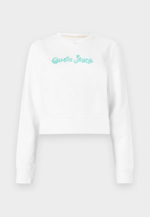 Weißer, gekürzter Sweatshirt mit Rundhalsausschnitt, ausgestattet mit türkisfarbenem "Guess Jeans"-Text in einer stilisierten Schriftart. Weicher Stoff mit gerippten Bündchen.