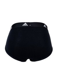 Svart bomullsunderkläder med en bred svart midjeresår som har vit Adidas-logotyp och tre ränder, slät textur och högskuren benlinje.