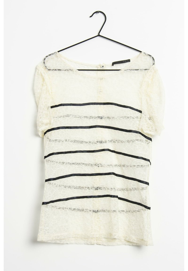 Haut en dentelle crème avec des rayures noires horizontales. Présente des manches courtes et une fermeture à bouton à l'arrière. Tissu doux et texturé.