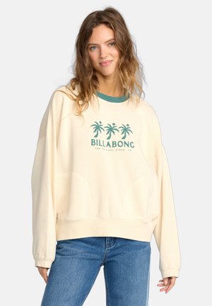 Crème-kleurige sweatshirt met groene ribgebreide halslijn, met een grafische print van palmbomen en "BILLABONG" in teal. Vrije pasvorm en zachte textuur.