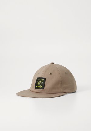 Tan cotton cap with a curved brim and a round top, featuring a square black patch with yellow text and graphic design.