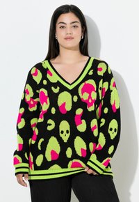 Schwarzer oversized Pullover mit V-Ausschnitt, verziert mit leuchtend grünen und pinken Totenkopf- und Leopardenmustern. Gerippte Bündchen und Saum.