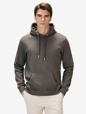Mørkegrå hoodie i blødt materiale med en frontlomme, justerbare snore og ribbede manchetter, båret over lyse bukser.
