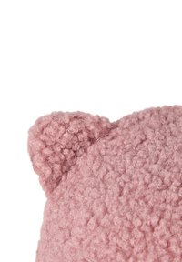 Close-up of soft pink knitted fabric showing a rounded bear ear detail on a textured, fuzzy surface.