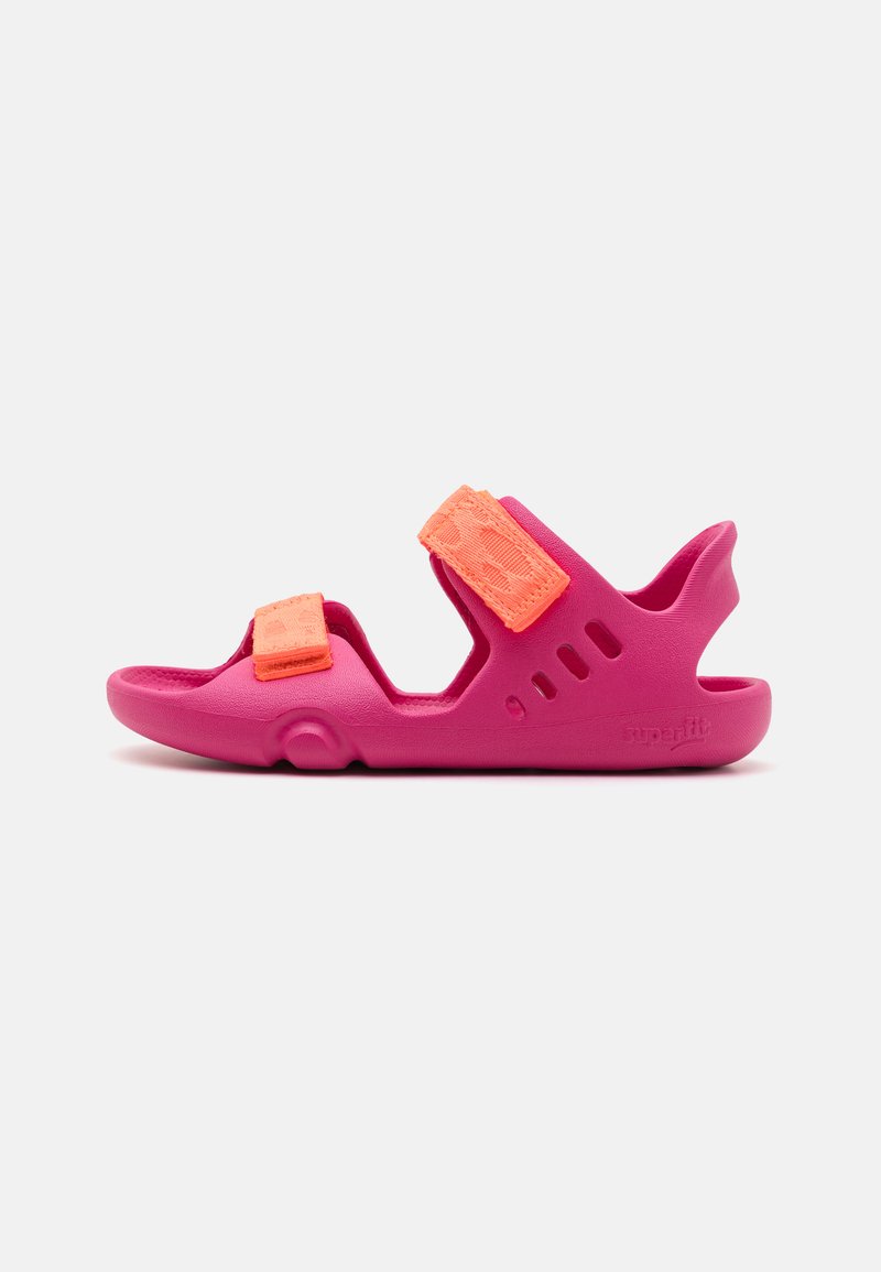 Bright pink sandals featuring two adjustable orange Velcro straps, a textured surface, cutouts for breathability, and a curved heel.
