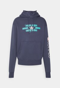 Marinblå bomulls-hoodie med framficka, med ett turkost grafiskt tryck med text och en Adidas-logotyp. Långa ärmar med vit text på höger sida.