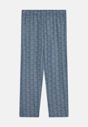 Pantalons de survêtement bleus à motif avec une taille élastique. Le tissu présente un design géométrique avec un petit logo vert sur le côté gauche.