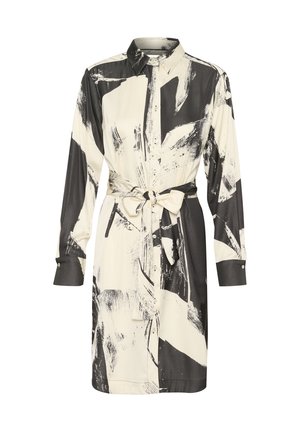 Kreminės spalvos marškinėlių suknelė su juoda abstrakčiu šešėliavimo raštu, ilgos rankovės ir juosmens surišimo detalė. Minkšta, lygi medžiaga.