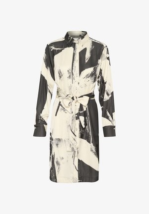 Kreminės spalvos marškinėlių suknelė su juoda abstrakčiu šešėliavimo raštu, ilgos rankovės ir juosmens surišimo detalė. Minkšta, lygi medžiaga.