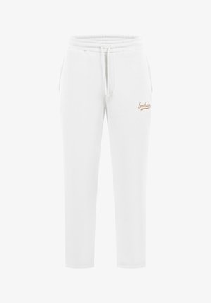 Pantalones de chándal blancos de algodón con cinturilla elástica y cordón ajustable. Presenta un pequeño logotipo beige en la parte superior de la pierna. Diseño ajustado.