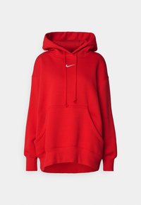 Röd hoodie i mjukt tyg med dragsko-huva, framficka i kängurustil och en liten vit Nike-logotyp på bröstet.