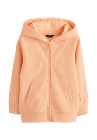 Hoodie zippé pêche en tissu doux avec une fermeture éclair sur le devant, deux poches latérales et une capuche doublée. Manchons et ourlet côtelés.