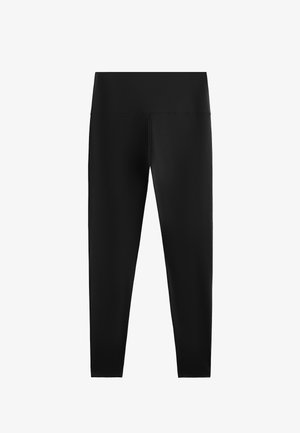 Črne visokotcane legice polne dolžine z gladkim, elastičnim pasom in brez vidnih logotipov ali vzorcev.