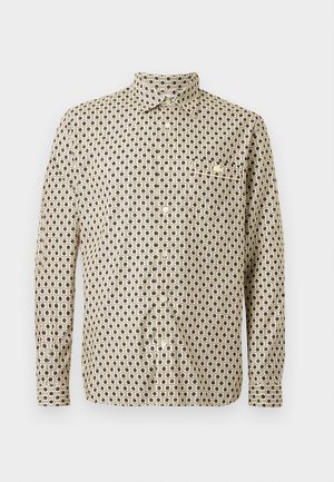 Camicia a maniche lunghe beige con un motivo geometrico nero, dotata di una tasca singola e colletto con bottoni. In cotone; vestibilità regolare.